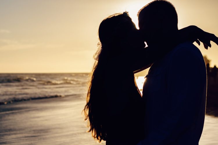 A couple kissing on the beach